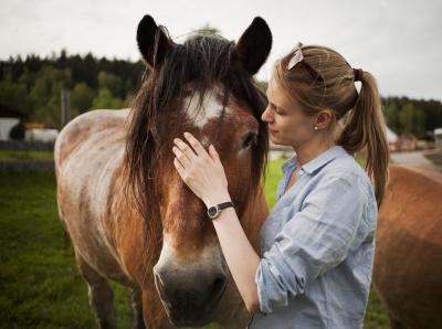 frau streichelt ein pferd